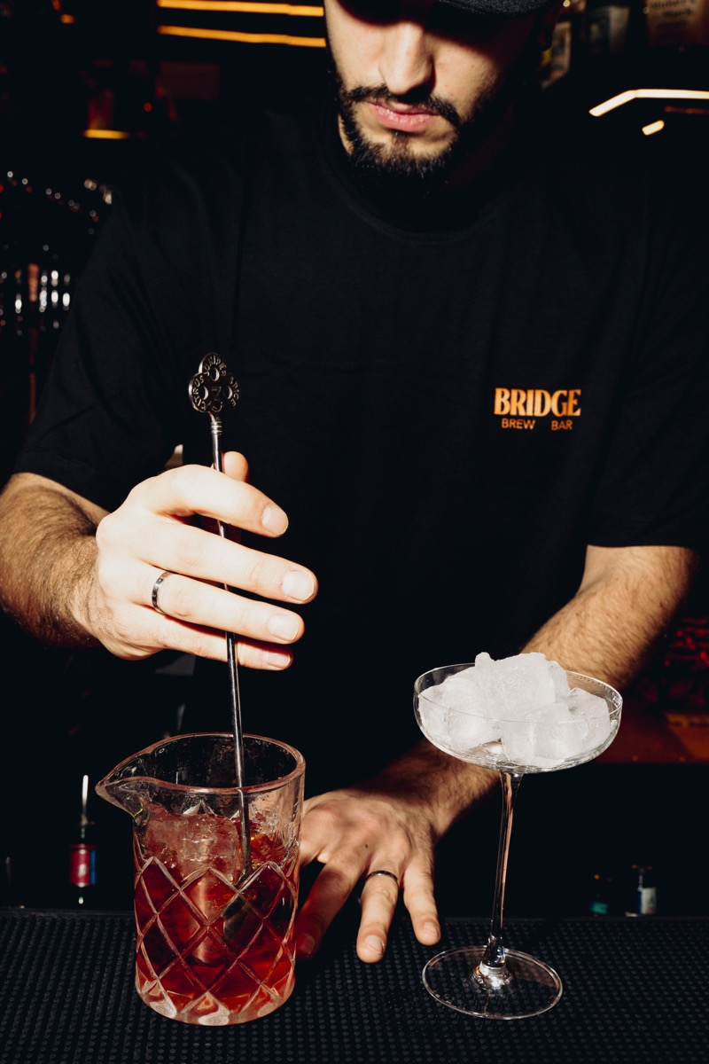 Bartender mixing drinks at Bridge Brew Bar